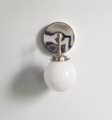 single chrome sconce with white shade