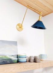 Lagoon and Brass adjustable cone swing arm wall sconce above kitchen shelving