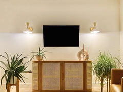 Neutral living room with mid century modern wall sconces by sazerac stitches