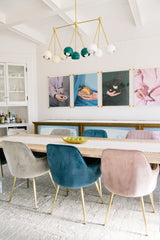 Dining room with long table and modern chandelier in shades of cream, white, and mermaid green.  Bright and airy dining room design