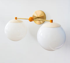 Cream and orange colorblocked two light bathroom vanity light