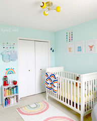 gender neutral nursery with a yellow and brass mid century modern inspired flushmount with white daisy flowers