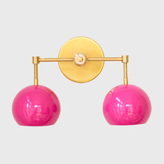 Bright Pink and brass two light mid century modern wall sconce  - front view