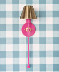 hot pink and brass wall sconce on gingham paper