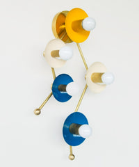 Astrology inspired sconce in mustard, cream, and blue.  Shaped like part of the Gemini star constellation