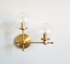 brass and clear glass globe L shaped wall sconce modernist midcentury modern contemporary wall lighting