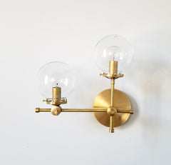 brass and clear glass globe L shaped wall sconce modernist midcentury modern contemporary wall lighting