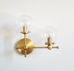 brass and clear glass globe L shaped wall sconce modernist midcentury modern contemporary wall lighting