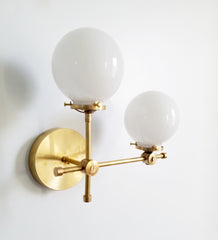 brass gold and white glass globe L shaped wall sconce modernist midcentury modern contemporary wall lighting