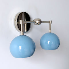 light blue and chrome two light bathroom vanity sconce