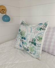 Light blue and brass wall sconce with an on-off switch next to a bunk bed