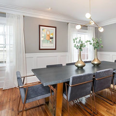 Glam gray and brass Emery chandelier over a long dining room table
