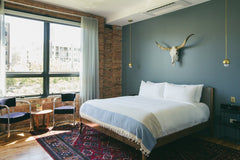 Brass Pendant lights as bedside lighting.  Small bedroom lighting solution.  Boho bedroom decor.