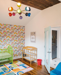 Prism Chandelier in a colorful nursery with rainbow wallpaper, lime green crib, and geometric area rug. Mid-century modern rainbow sputnik ceiling light adds dopamine décor energy and playful eclectic style, making this kids’ room vibrant and unique.