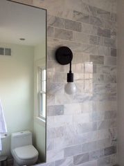 marble tile bathroom remodel black light fixture black sconce laurel sazerac stitches home renovation