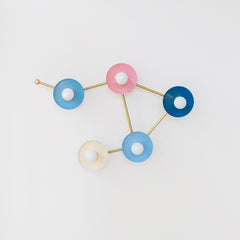 pastel pink blue cream and blue grey wall sconce in the shape of a libra star constellation