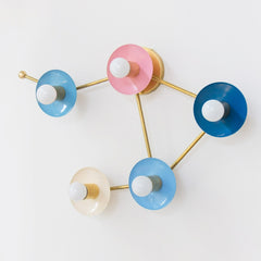 pastel pink blue cream and blue grey wall sconce in the shape of a libra star constellation