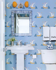 Orange and blue kids bathroom with a nautical wallpaper