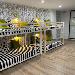 chartreuse and brass loa wall sconce in a black and white room with bunk beds