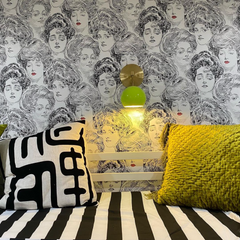 chartreuse and brass loa wall sconce in a black and white room with bunk beds