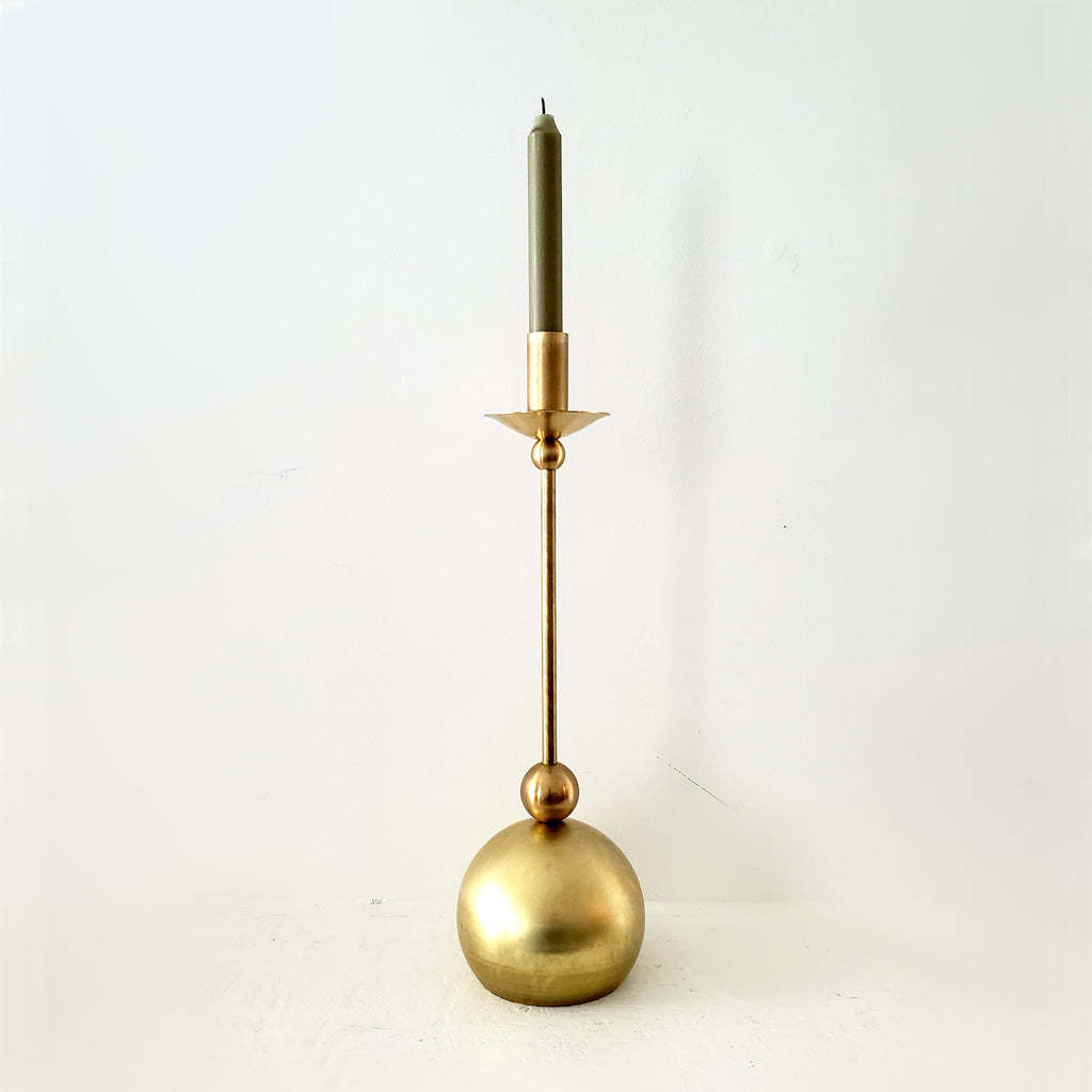 Brass taper candle holder with geometric shapes and a globe base