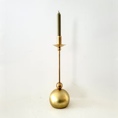 Brass taper candle holder with geometric shapes and a globe base