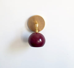 brass and black cherry maroon eyeball wall sconce