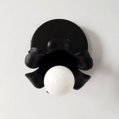 Adjustable victorian modern wall sconce in a black matte finish and floral shape