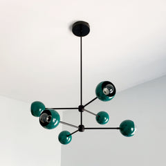 Green and black modern chandelier inspired by midcentury modern design in fun colors