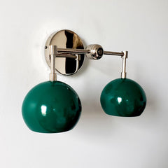 green and chrome two light wall sconce with mid century modern green globe shades