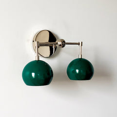 green and chrome two light wall sconce with mid century modern green globe shades
