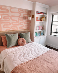 Blush pink tonal bedroom makeover with wallpaper, bedding, and pillows in the same shades of pink