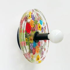multi-colored floral wall sconce with real dried flowers and leaves.  Black hardware