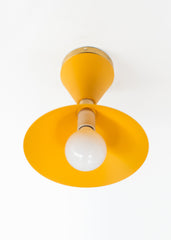 Mustard & Brass flushmount ceiling light in a mid-century modern style shape