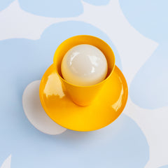 bright yellow mid century modern style wall sconce or ceiling light