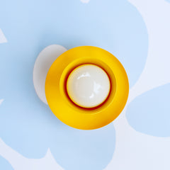 bright yellow mid century modern style wall sconce or ceiling light - front view