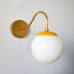 Mustard and brass mid century modern inspired globe wall sconce