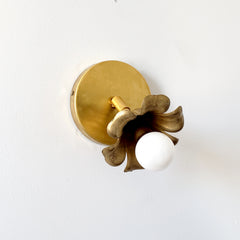 Adjustable Floral Sconce by Sazerac Stitches features floral brass flowers and a candelabra socket