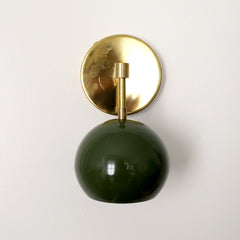 Olive green mid century modern globe wall sconce with brass hardware