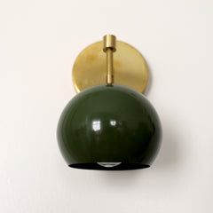 Olive green mid century modern globe wall sconce with brass hardware