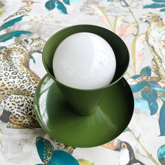 olive green mid century modern wall sconce or flushmount ceiling light on tropical wallpaper