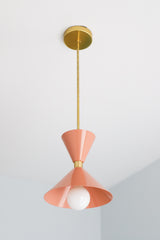Peach and brass mid century modern inspired pendant light fixture for kitchen island design