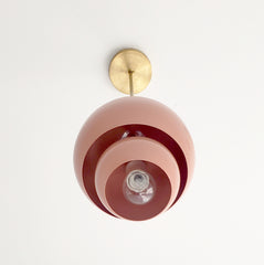 Peach and brass nesting midcentury modern inspired pendant light with nesting shades