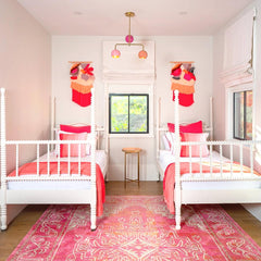 pink and peach colorful girls bedroom with two beds. 