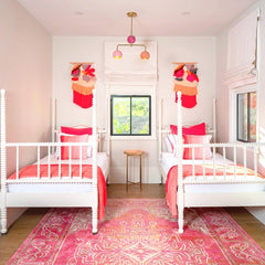 pink and peach colorful girls bedroom with two beds.