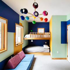 Prism Chandelier in a bold kids’ bedroom with bunk beds, colorful geometric wall paint, and playful mid-century modern rainbow lighting. A vibrant dopamine décor ceiling light that mixes bright colors with eclectic design for fun family homes and modern interiors.