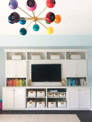 Rainbow chandelier in a white office with storage