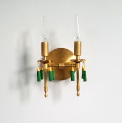 Modern victorian wall lighting sconce features cast gold brass bobeches and green beaded tassels