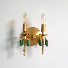 Modern victorian wall lighting sconce features cast gold brass bobeches and green beaded tassels