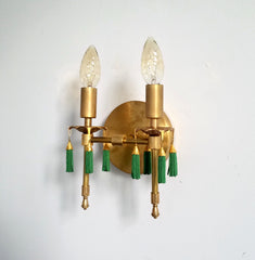 Modern victorian wall lighting sconce features cast gold brass bobeches and green beaded tassels